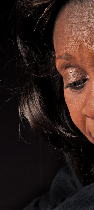 sad or serious woman with dark background