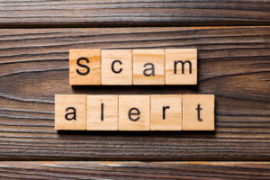 scam alert on wood tiles