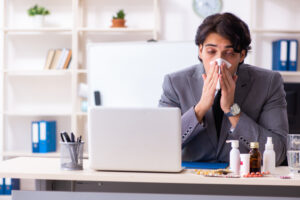 sick man at work in office