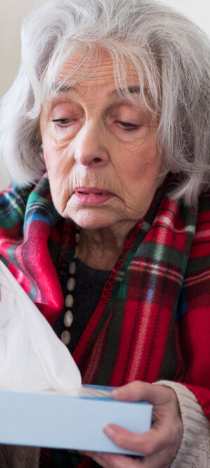 sick older woman with tissues