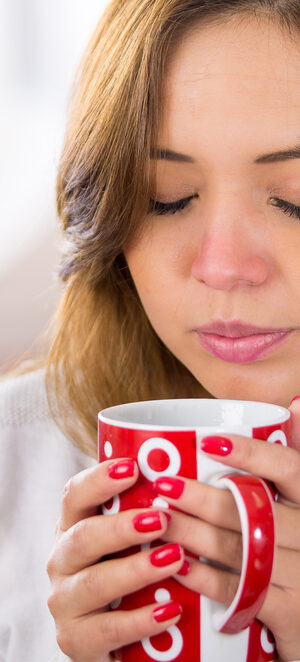 sick woman with hot drink mug