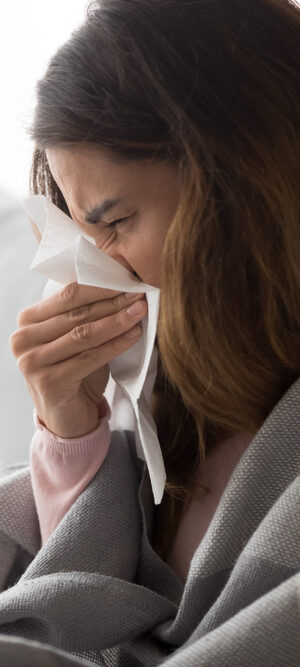 sick young woman with kleenex