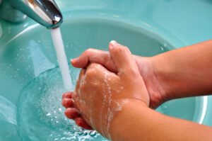 soapy hands with aqua sink