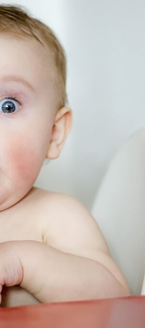 surprised baby with red cheeks