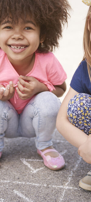 two little girls outside playing