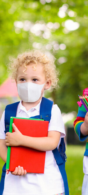 two young girls wearing face coverings for school