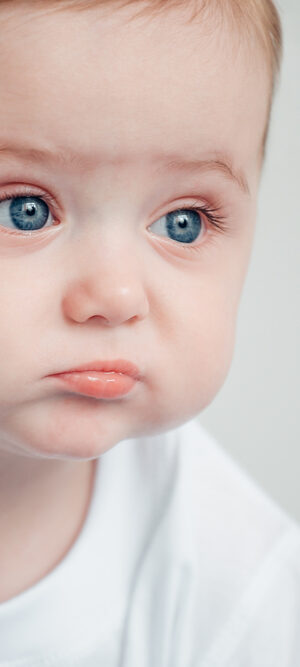 unhappy baby in white tshirt