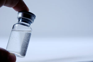 vaccine bottle with hand
