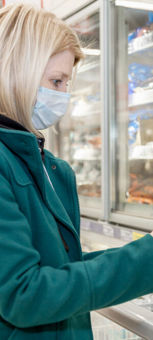 woman shopping for groceries with face covering