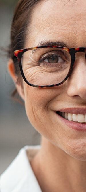 woman with glasses smiling