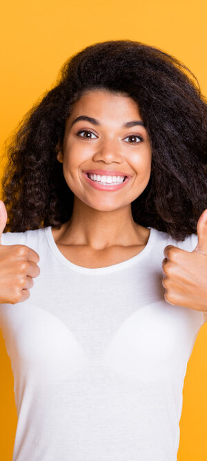 woman with thumbs up and yellow background