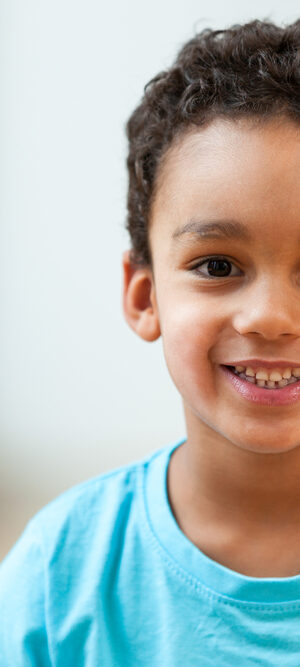 young boy in turquoise tshirt