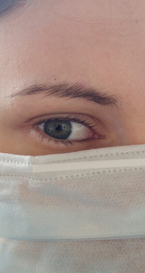 young woman close up with face covering