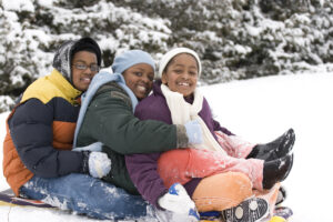 Three children on a sled in the snow