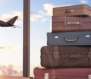 A stack of suitcases with airplane taking off in the background